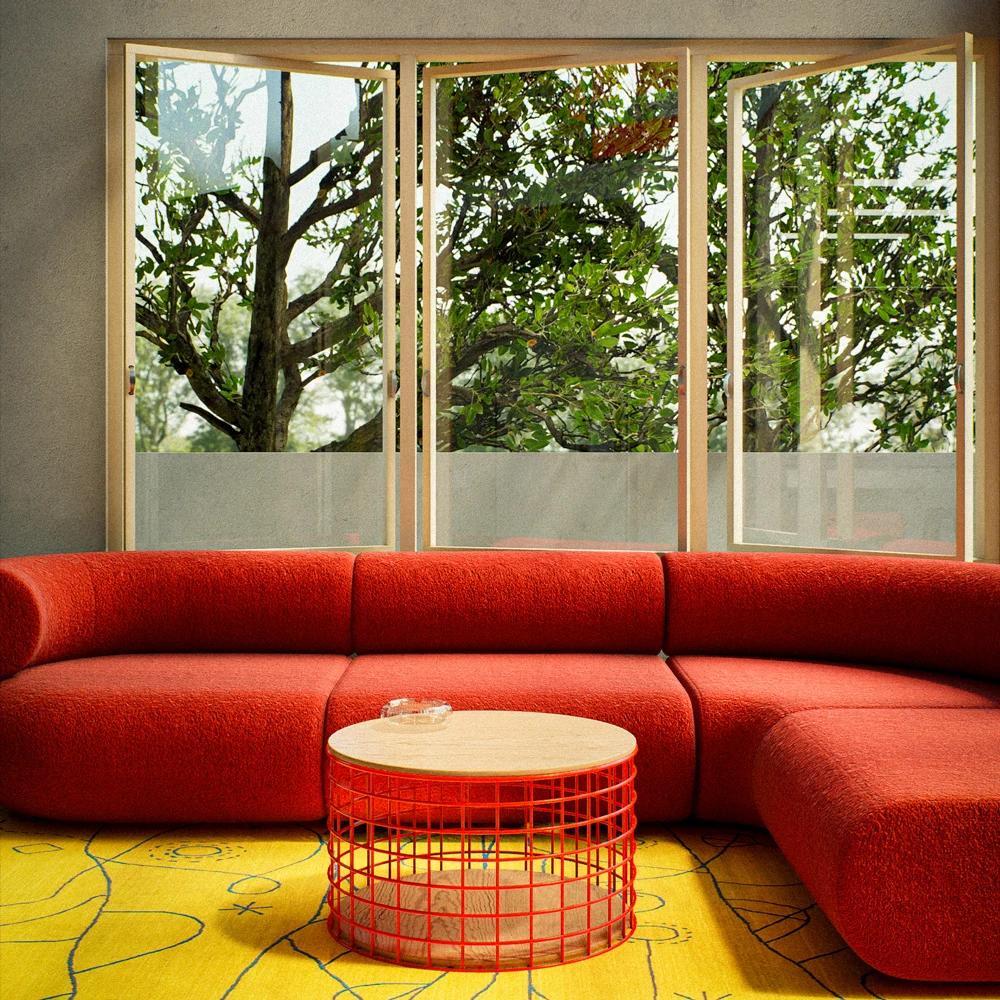 Red corner sofa and round table on a yellow rug beside tall windows