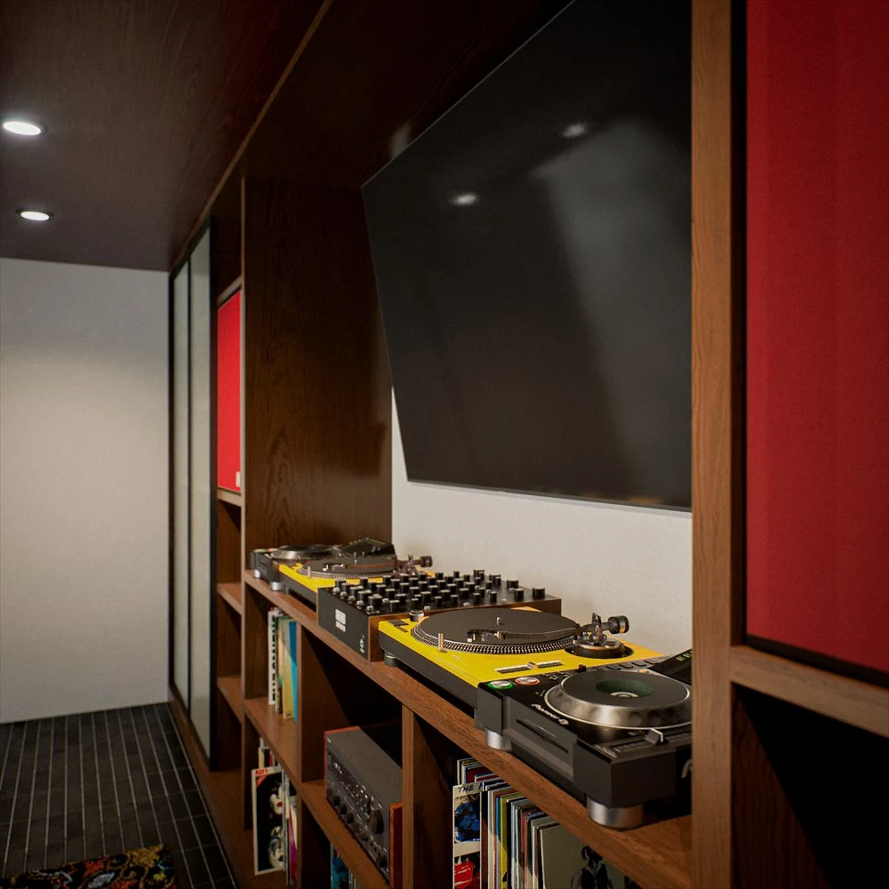 Turntables and records along a wall with red panels