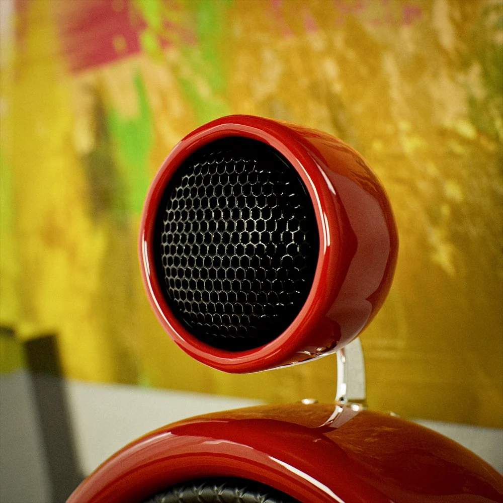 Close view of a small black grille in a red speaker housing