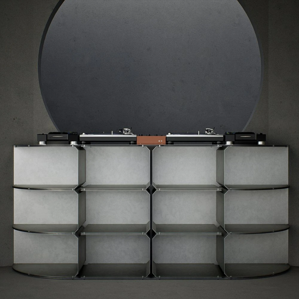 Grey DJ table with a recessed grid beneath a circular wall feature