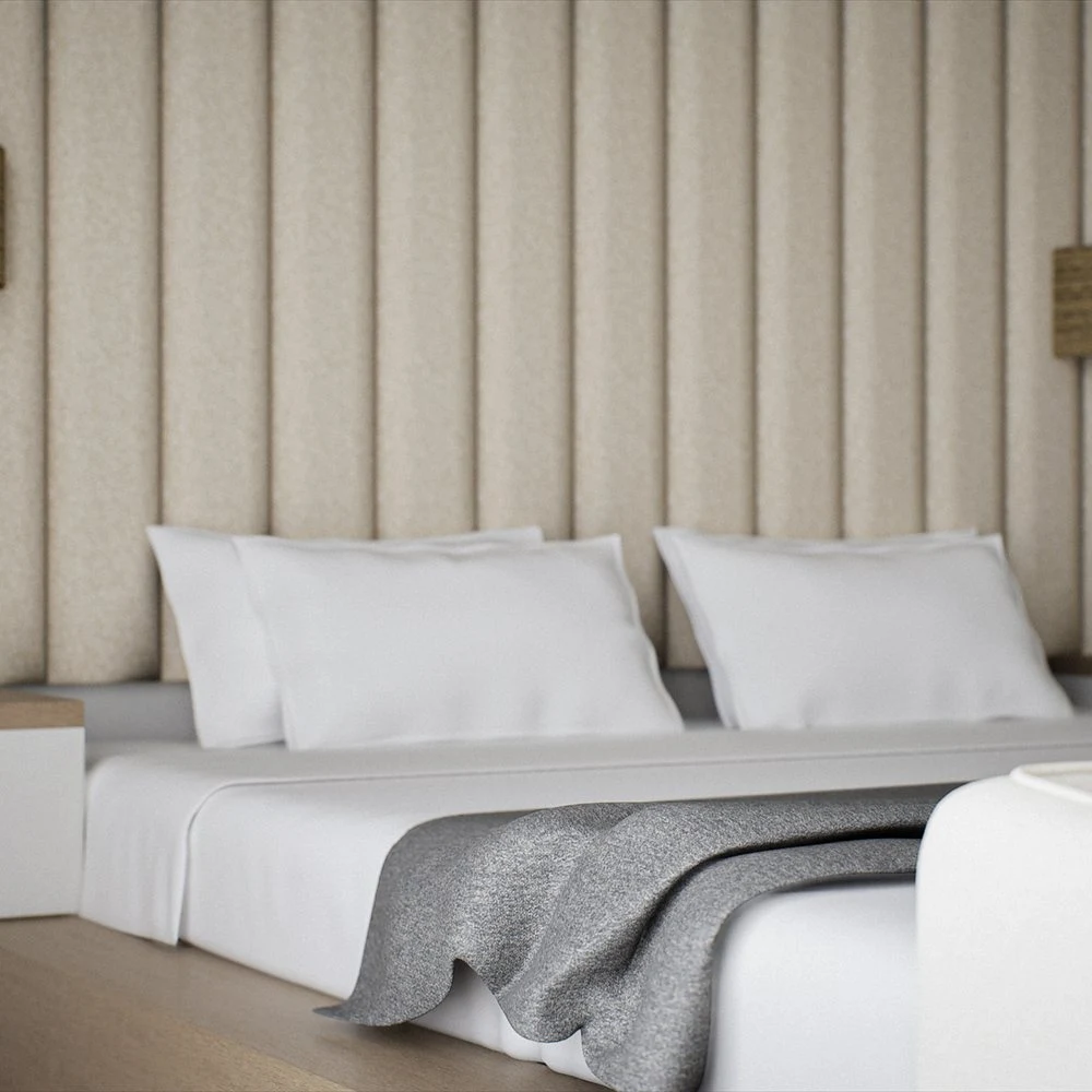 Angled view of pale bedding and woven bedside lamps